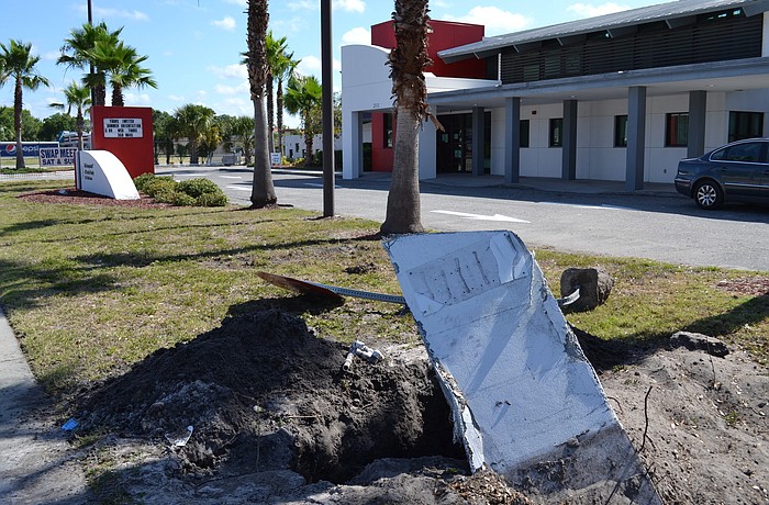 The force of the collision uprooted a large concrete pole.
