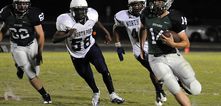 Sophomore quarterback Zach Reda runs up the sideline during the Mustangs Spring Game May 27.