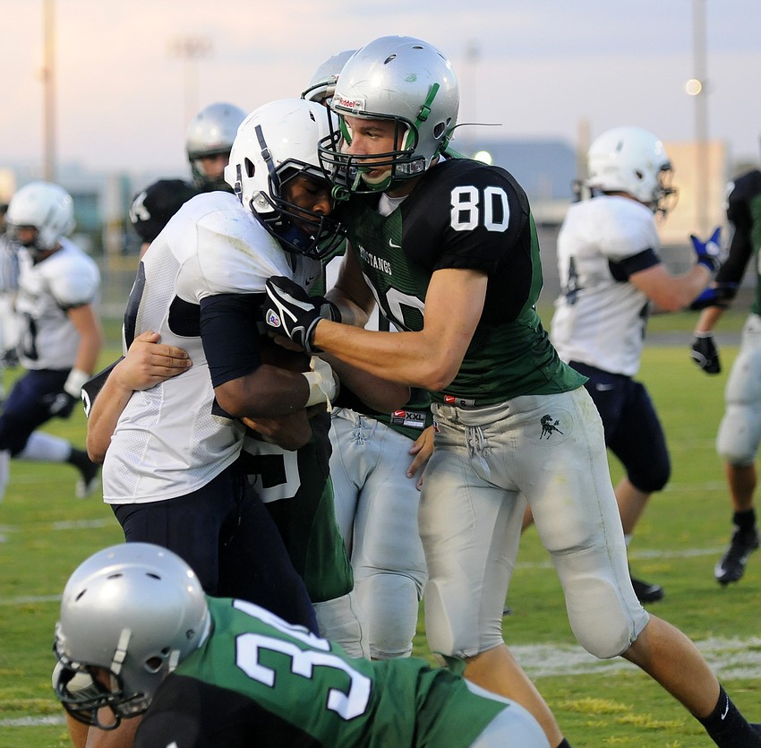 Juniors Josh Rogers and Sam Slade prevent North Port from getting a big gain.