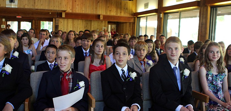 Students smile and listen to Ken Melber speak Friday, June 3 during ODA's 6th grade graduation at Siesta Key Chapel. This was Melber's final year at ODA and he will be heading back to England.