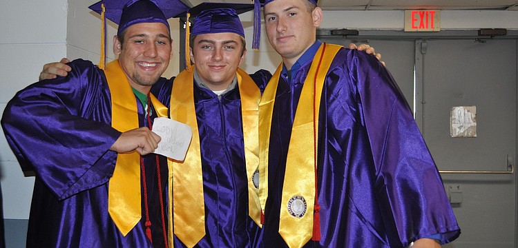 Cody Taylor, Keith Summerall and Eric Kay are pumped up to cross the stage and receive their diplomas.