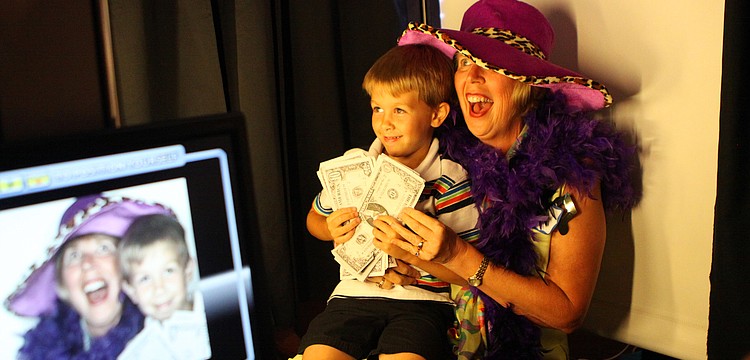 Terri Bauer and nephew, Joshua DeCrapio, 5, pose in the Fotos-R-Fun LLC booth at the annual National Cancer Survivors Day celebration Sunday, June 5 at Michael's on East. Bauer has been cancer free for eight years.