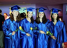 Colleen Wohlrab, Arianna Robbins, Mary Beth Bilder and Yvonne Hoang pose in their caps and gowns with their yellow flowers prior to their graduation from Pineview High School Sunday, June 5 at Van Wezel.