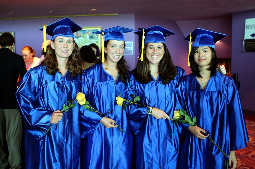 Colleen Wohlrab, Arianna Robbins, Mary Beth Bilder and Yvonne Hoang pose in their caps and gowns with their yellow flowers prior to their graduation from Pineview High School Sunday, June 5 at Van Wezel.