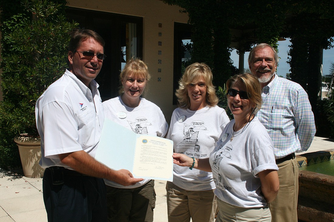 Dennis Matthews, Jennifer Wilson, Tina Straley, Phyllis Thomas and David Kemp held a proclamation issued by the town of Longboat Key at the 2009 National Marina Day.