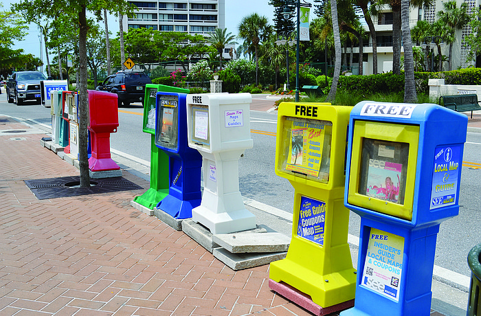 The strip of 12 individual newspaper and magazine boxes at Ocean Boulevard and Calle Miramar would be replaced by two homogenous green boxes to hold all of those publications.