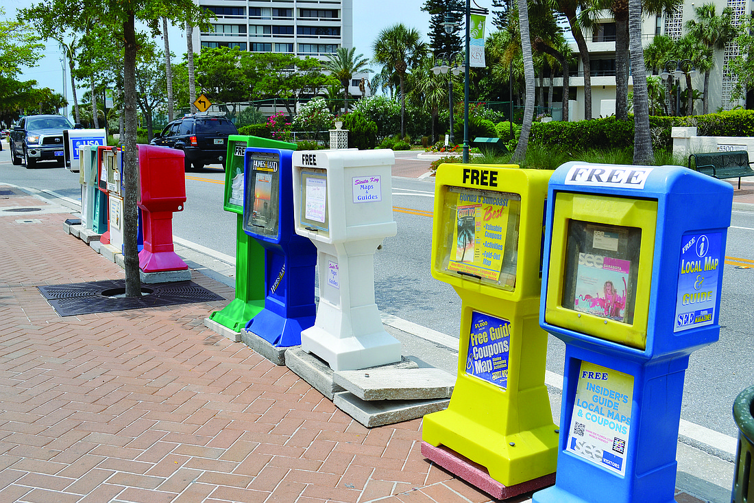 The strip of 12 individual newspaper and magazine boxes at Ocean Boulevard and Calle Miramar would be replaced by two homogenous green boxes to hold all of those publications.