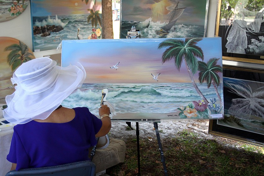 Kyung A. Park works on a painting while at the 10th Annual St. Armands Craft Festival Saturday June, 11 at St. Armands Circle.