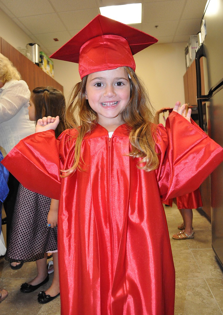 Five-year-old Mia Offer was one of the first one's to put on her cap and gown.