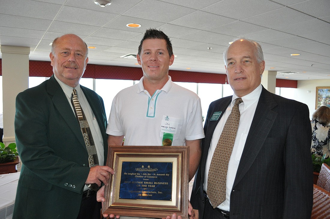Cal Bonnett, left, and Dennis Hassell, right, presented Jay Anderson of Edgewater Contracters Inc., with the Rookie Small Business award at last year's event.
