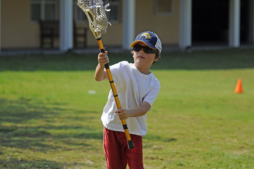 Seven-year-old Joshua Siegel practiced his stick skills while trying to score a goal.