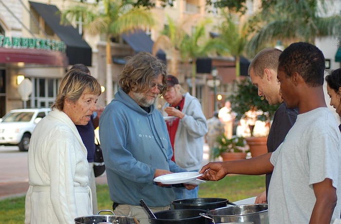 Downtown residents believe frequent feedings of homeless people downtown attract criminal vagrants.