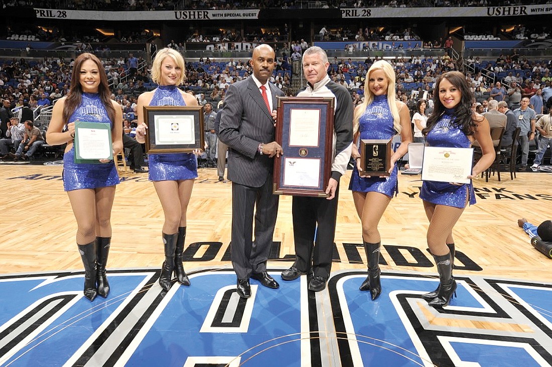 Bob Delaney received five awards during a center-court ceremony before his final regular season game April 13 in Orlando.