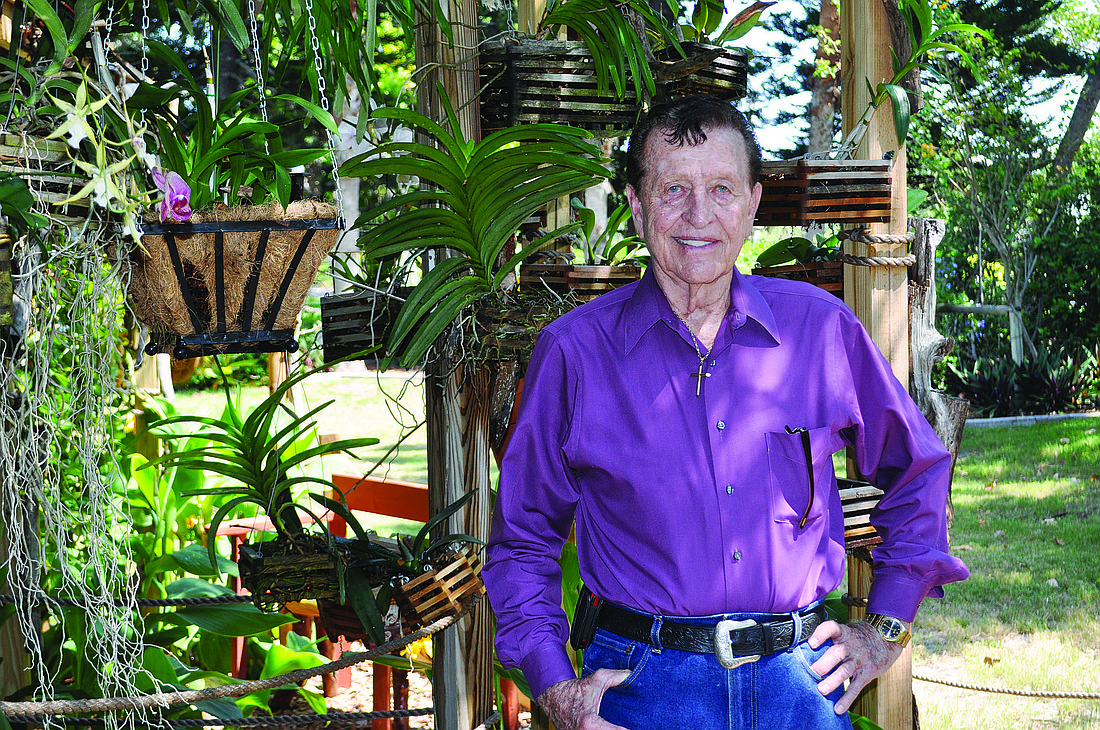 Casa del Mar General Manager D.M. Williams stands in the orchid garden, near the sign that the resortÃ¢â‚¬â„¢s board gave him at its annual meeting.