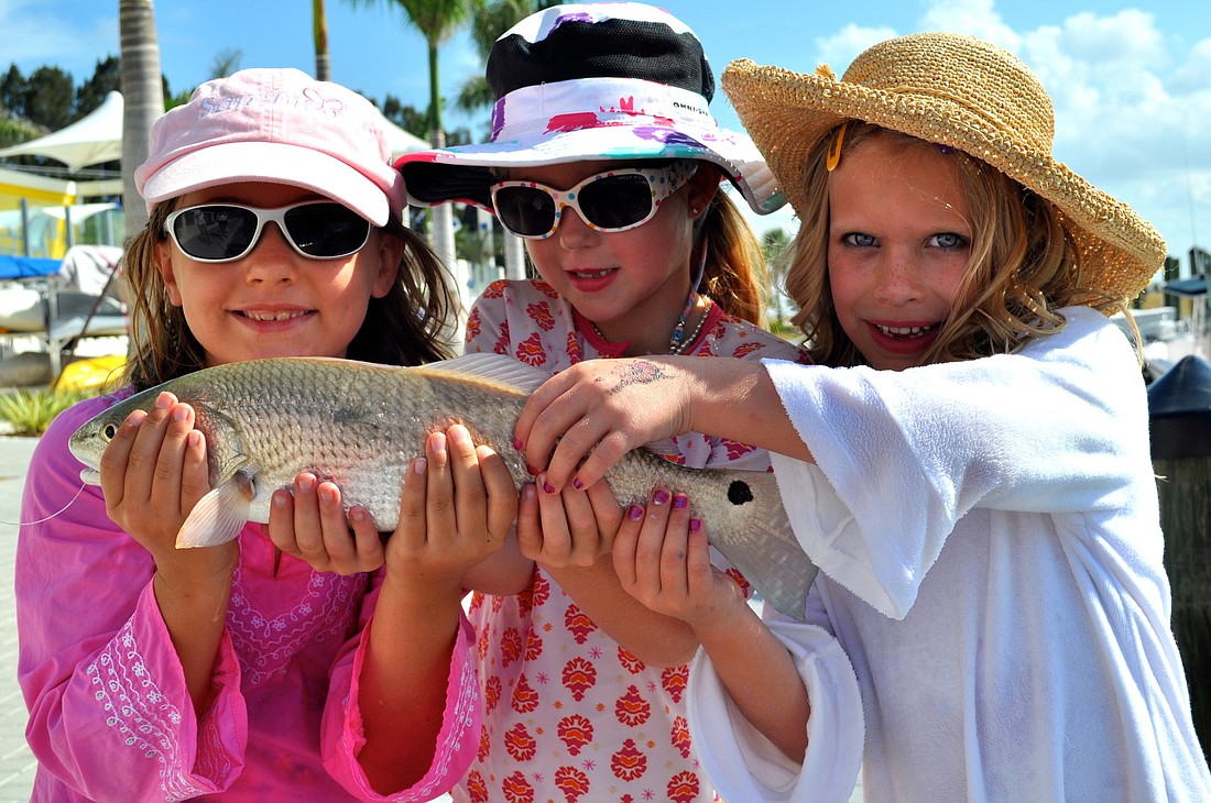 Emily O'Neill, Kendall Dooley and Ella Williams proudly show off Kendall's first catch of the day.