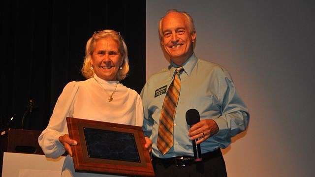 Lee Fox, Save Our Seabirds, accepts the non-profit award from Dennis Hassell.