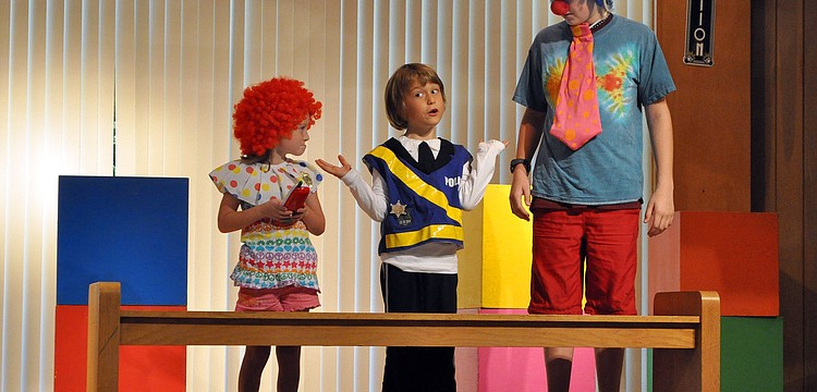 Gabriel Mirman, as Police Cheif O'Reilly, gives Emma Melton, as Deputy Jessy Zingo, and Brian Steele, as Deputy Zac Horton, a hard time about working with clowns in the mystery play "The Curious Case of the Undercover Clowns".