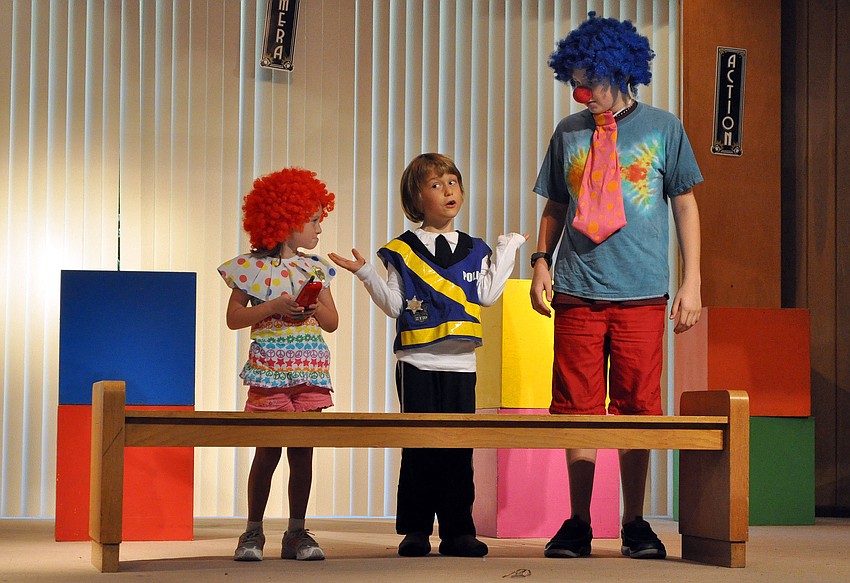 Gabriel Mirman, as Police Cheif O'Reilly, gives Emma Melton, as Deputy Jessy Zingo, and Brian Steele, as Deputy Zac Horton, a hard time about working with clowns in the mystery play 