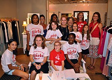 The girls and women involved in the Girls Inc.Credible summer camp at Girls Inc. pose Saturday, June 25 inside Lotus, one of the five stores on Main Street that allowed the girls to try sell their own creations.