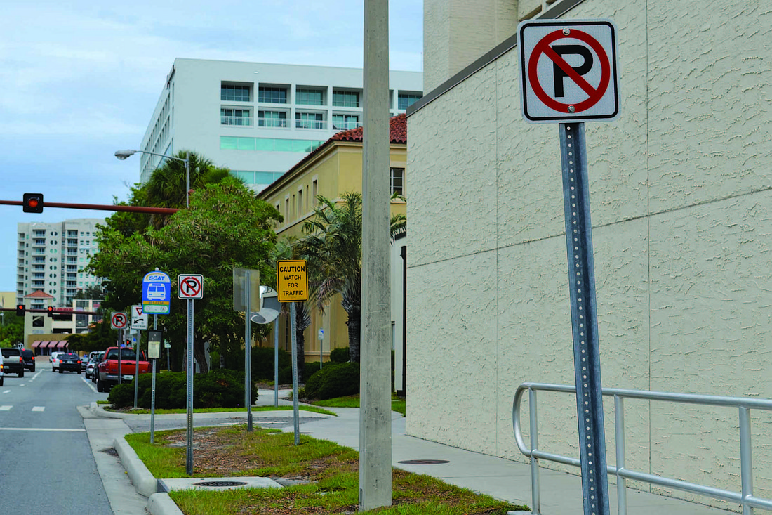 This photo of Ringing Boulevard, in front of the county jail, shows three no-parking signs within about 30 feet, as well as four other signs in the same space.