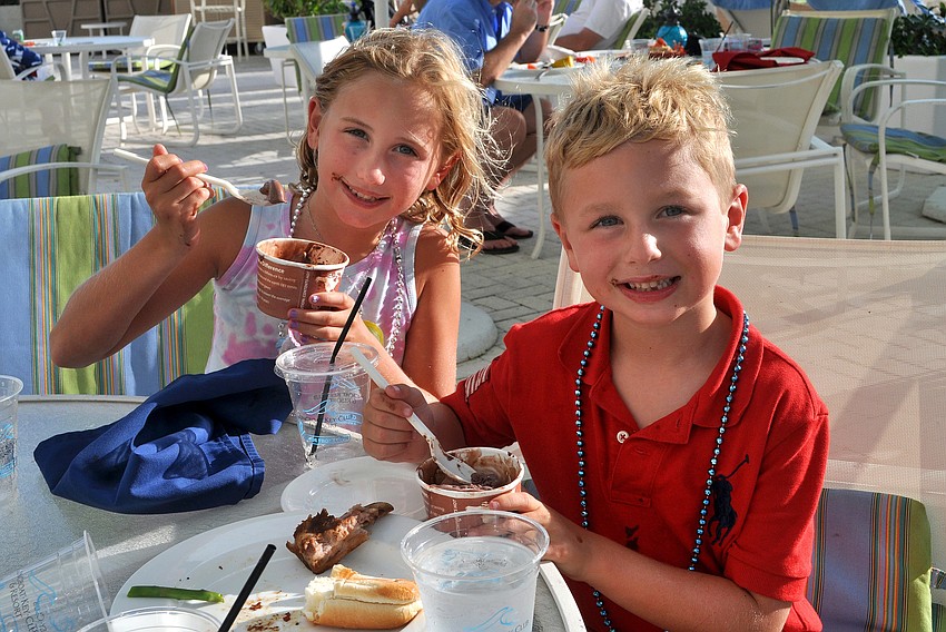 Sabrina, 8, and Jake, 6, Kreiss enjoy some chocolate ice cream Sunday, July 3 at the Lobster BBQ by the pool at Longboat Key Club Resort.