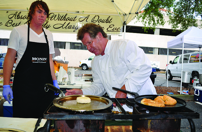 Kyle Klante watches as Chef James Besterre, of Annalida's, fries a crab-cake sandwich.