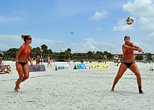 Livia Mendonca hits the ball as Melissa Roberts prepares to help out her teammate during the Siesta Key Gulf Open, Saturday, July 9 at Siesta Key Beach.