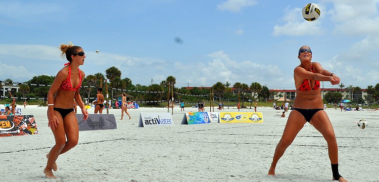 Livia Mendonca hits the ball as Melissa Roberts prepares to help out her teammate during the Siesta Key Gulf Open, Saturday, July 9 at Siesta Key Beach.