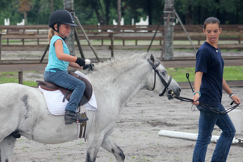 Lilly Nace competed in the egg race with some assistance from Alex Marler.