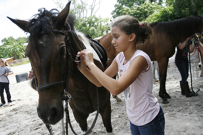 Eliza Puleo, 8, is learning to ride her older sister's horse.