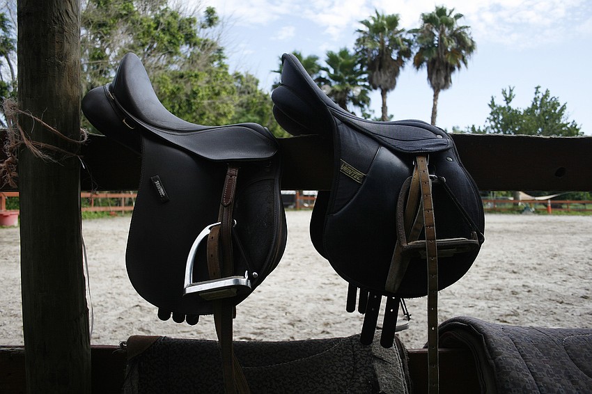 Each student learns to saddle a horse during the camp.