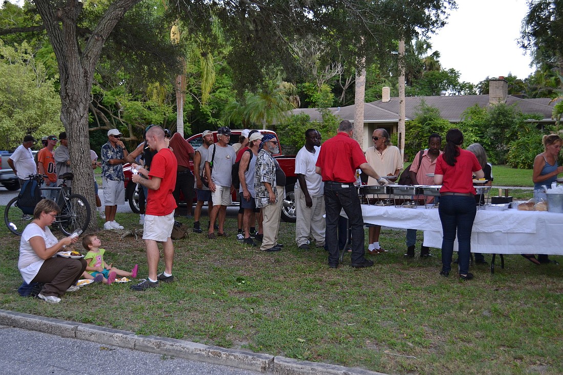 About 40 homeless people were fed in front of Vice Mayor Terry Turner's Cherokee Park home.