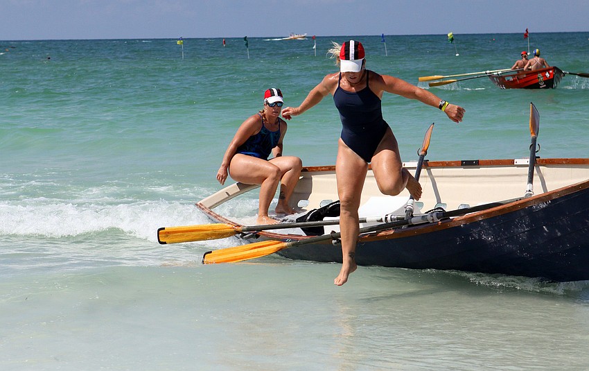 Sherry Griffith jumps out of the dory while her twin sister, Shelly, gets ready to whip the boat back around to head back out into the Gulf of Mexico Thursday, July 14 during the 2011 James 