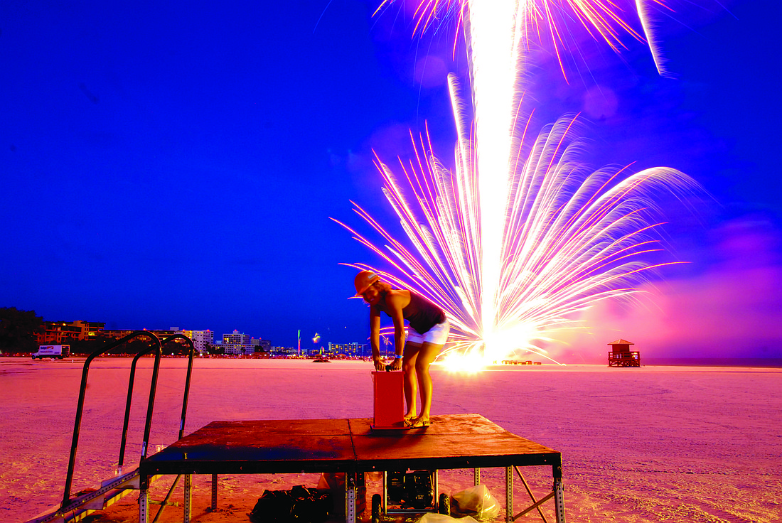 Holly Ferguson sets off the first firework July 4, on Siesta Key.
