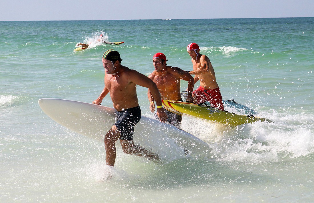 It was a close call between three of the lifeguards in the menÃ¢â‚¬â„¢s rescue board race Thursday, July 14 during the 2011 James "MAC" McCarthy Southeast Regional Lifeguard Competition.