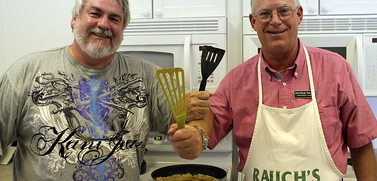 Mark Huber and George Rauch pose in the kitchen while they cooked the 35 fish they caught for the Saturday, July 16 Christ Church and Spanish Main fish fry.