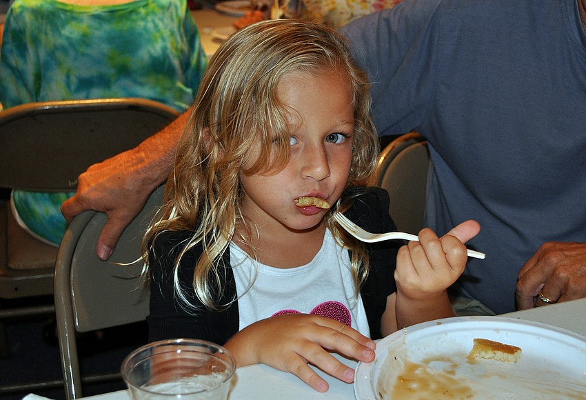 Lucy Zee, 5, takes a bite of one of her pancakes at the pancake breakfast put on by the Knights of Columbus Sunday, July 17 at St. Michael the Archangel Catholic Church.