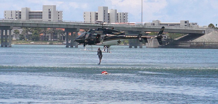 Matt Binkley, a deputy with the Sheriffâ€™s department, jumps from the helicopter into the water from about 10-feet up in the air in order to save a mannequin during the mock marine search and rescue mission.