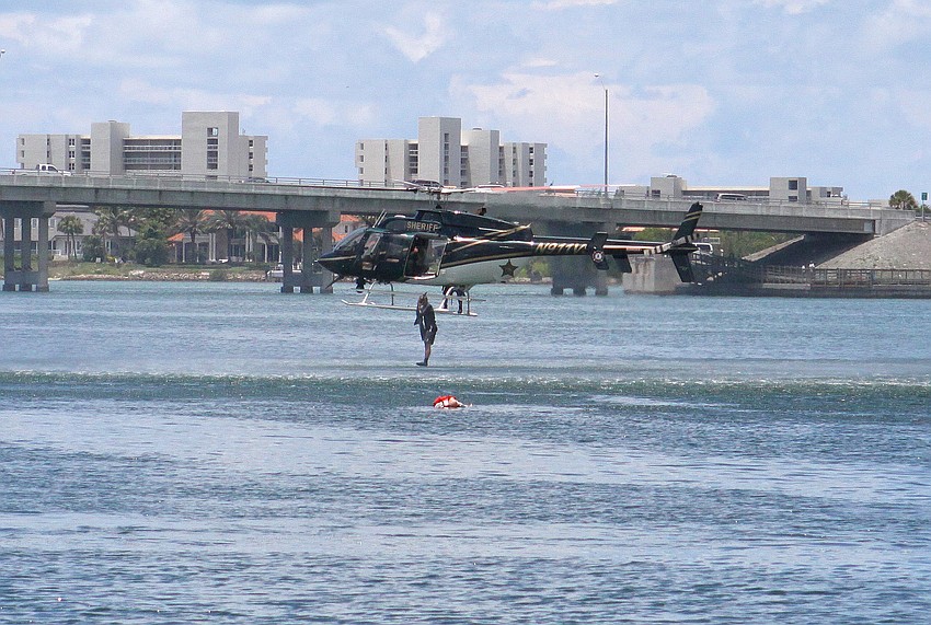 Matt Binkley, a deputy with the Sheriffâ€™s department, jumps from the helicopter into the water from about 10-feet up in the air in order to save a mannequin during the mock marine search and rescue mission.