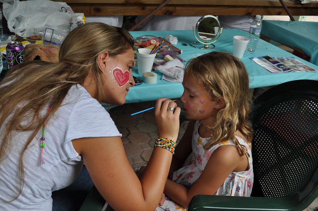 Ximena Fernandez painted hearts on Nicole Norwine's face at last year's Fish Fry.