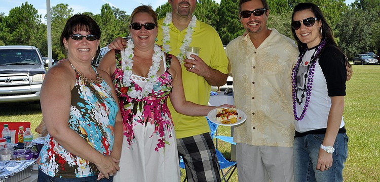 Paula Egan, Sandra Edwards, Matt Brannan, Brad Moyer and Stephanie Brannon of Integrity Title made a Hawaiian hot dog.