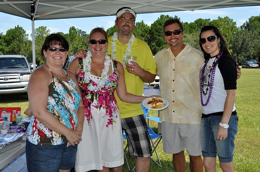 Paula Egan, Sandra Edwards, Matt Brannan, Brad Moyer and Stephanie Brannon of Integrity Title made a Hawaiian hot dog.