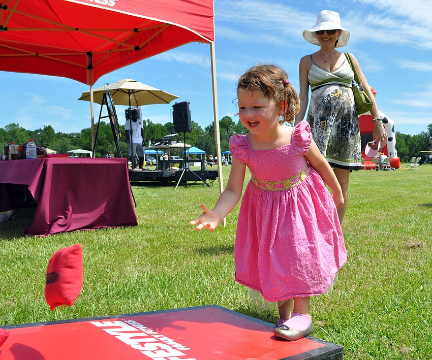 Three-and-one-half-year-old Katerina Sommers couldnâ€™t stop playing the beanbag toss.
