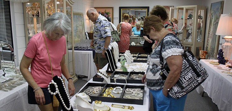 People browsed the jewelry and other trinkets that were for sale Friday, July 22 at the estate sale.
