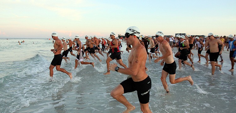 The first wave of Olympic triathletes hit the water at 7 a.m. Saturday, July 23 as part of the Siesta Key Triathlon out at Siesta Key Public Beach