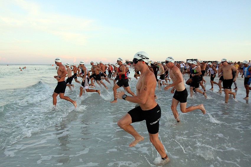 The first wave of Olympic triathletes hit the water at 7 a.m. Saturday, July 23 as part of the Siesta Key Triathlon out at Siesta Key Public Beach