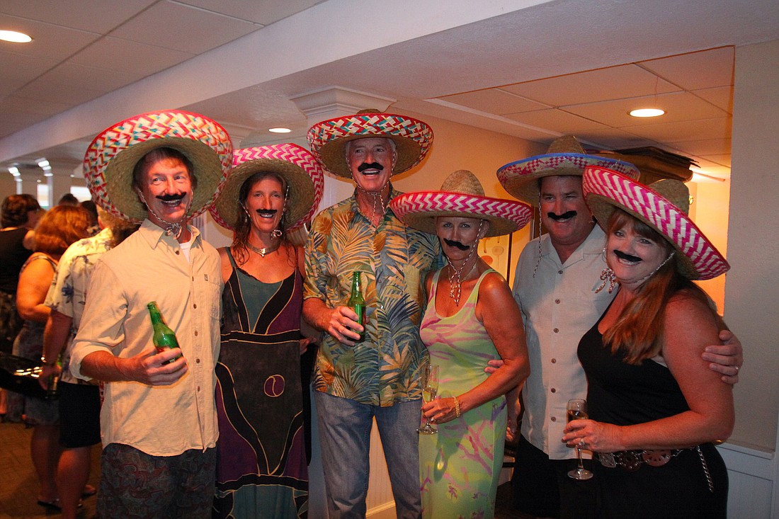 Mike and Cyndi Seamon, Bill and Meike Dooley and Chris and Patty Sileo dressed up in sombreros and mustaches.