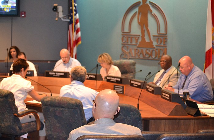 Sarasota city commissioners postponed a hiring freeze Tuesday at City Hall.