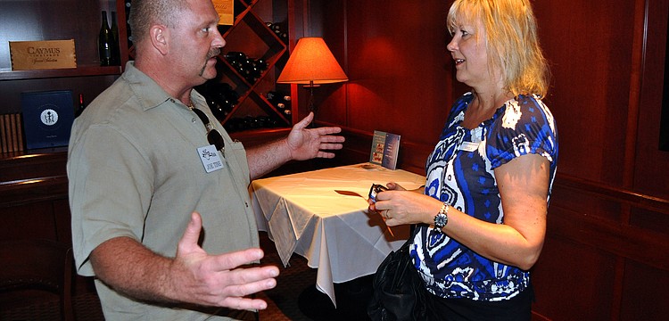 Joe Tine and Shelia Lewis talk about their business prior to having lunch Thursday, July 28 at Fleming's Prime Steakhouse & Wine Bar.