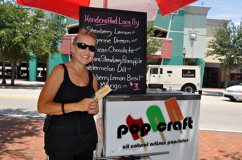 Donna Tortorice, co-owner of Pop Craft, poses out by her cart Monday, August 1 on the sidewalk across the street from Hollywood 20.